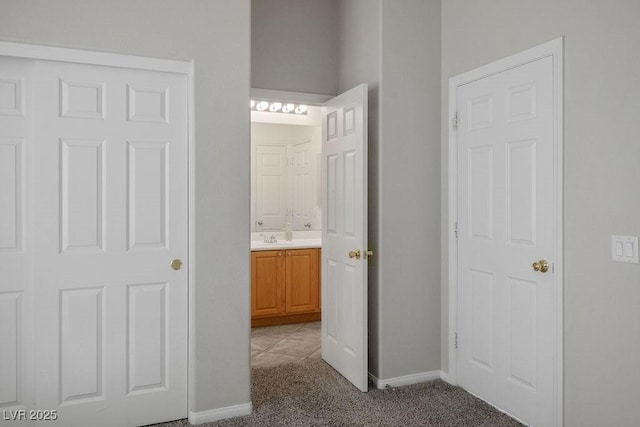5017 Kaibab Forest Ave, Las Vegas, NV 89141 - hallway featuring light carpet, a sink, and baseboards