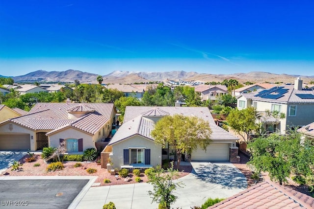 5017 Kaibab Forest Ave, Las Vegas, NV 89141 - mediterranean / spanish-style house with a residential view, a mountain view, driveway, a tile roof, and stucco siding