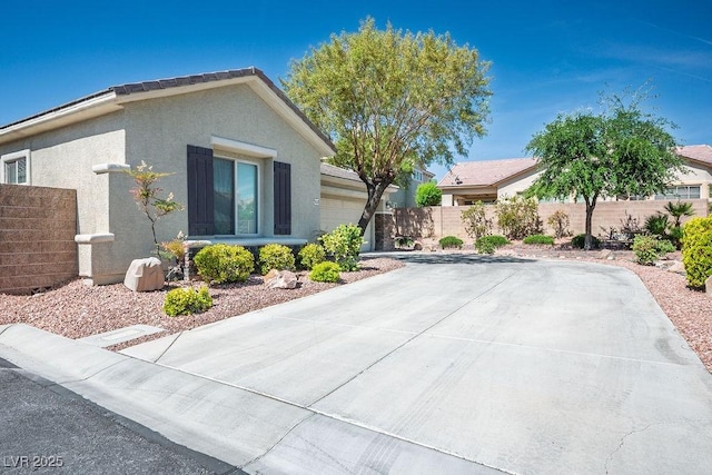 5017 Kaibab Forest Ave, Las Vegas, NV 89141 - view of front facade featuring an attached garage, stucco siding, and driveway