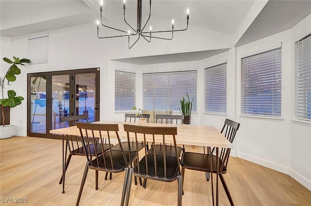 58 Pleasant Dale Dr, Henderson, NV 89074 - dining area with lofted ceiling, light wood finished floors, french doors, baseboards, and a chandelier