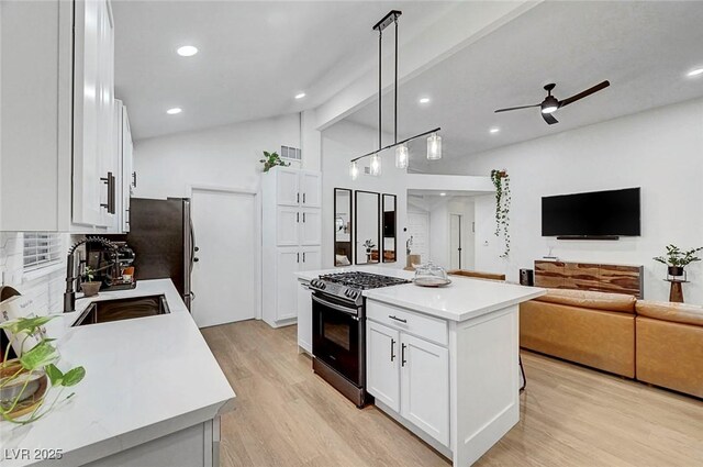 58 Pleasant Dale Dr, Henderson, NV 89074 - kitchen with stainless steel appliances, a sink, light countertops, light wood-style flooring, and lofted ceiling