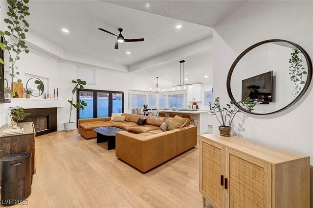 58 Pleasant Dale Dr, Henderson, NV 89074 - living area featuring light wood finished floors, a ceiling fan, a fireplace, a chandelier, and recessed lighting