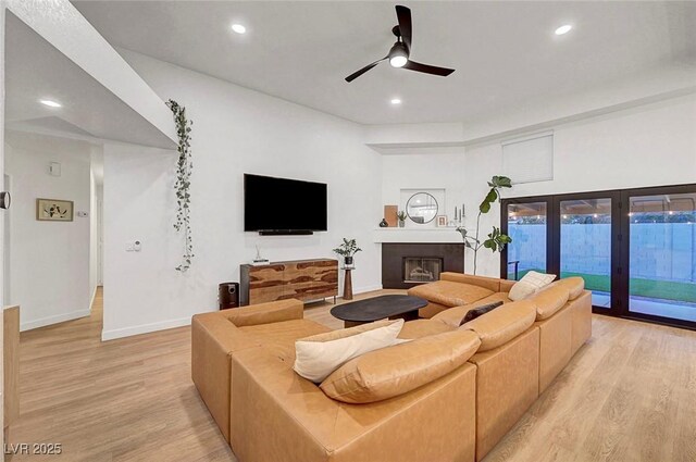 58 Pleasant Dale Dr, Henderson, NV 89074 - living room featuring light wood finished floors, a ceiling fan, baseboards, recessed lighting, and a fireplace