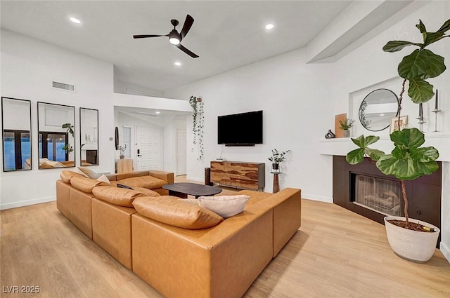 58 Pleasant Dale Dr, Henderson, NV 89074 - living room featuring light wood finished floors, a ceiling fan, a fireplace, recessed lighting, and baseboards