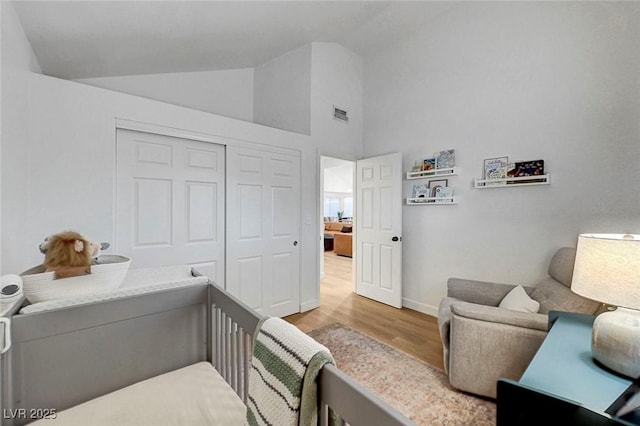 58 Pleasant Dale Dr, Henderson, NV 89074 - bedroom with wood finished floors, a closet, baseboards, and high vaulted ceiling