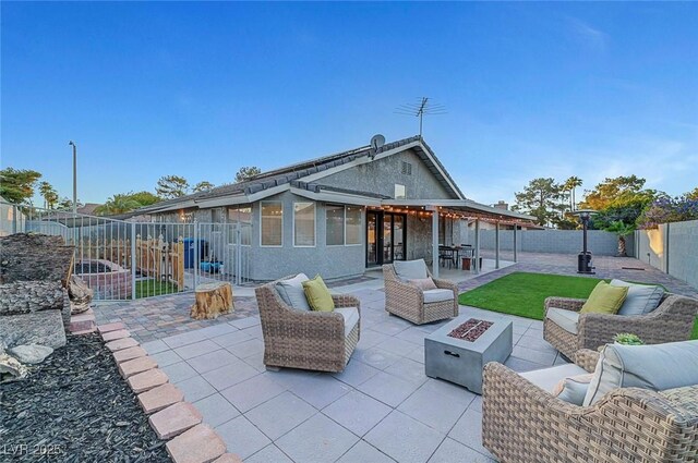 58 Pleasant Dale Dr, Henderson, NV 89074 - fenced backyard featuring a patio area and an outdoor living space with a fire pit