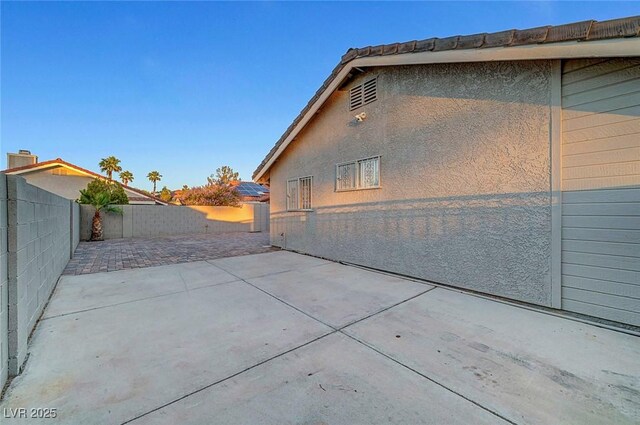58 Pleasant Dale Dr, Henderson, NV 89074 - view of home's exterior with a patio area, a fenced backyard, and stucco siding