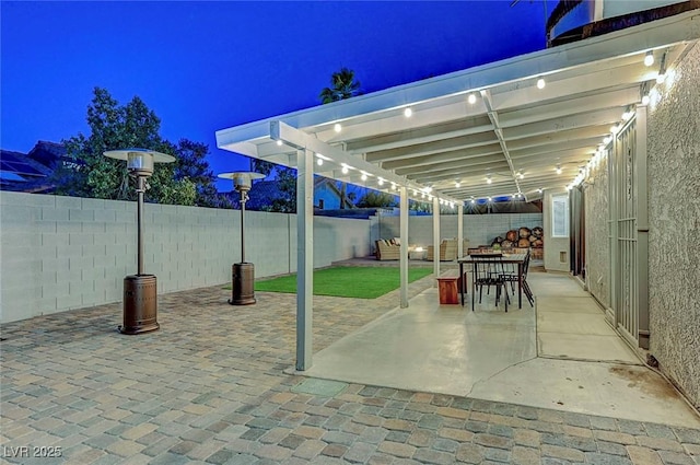 58 Pleasant Dale Dr, Henderson, NV 89074 - patio at twilight featuring a fenced backyard, outdoor dining space, a patio, and a pergola