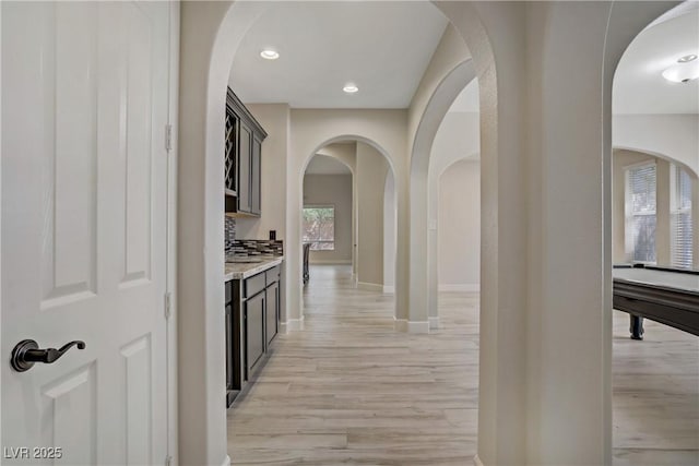 8544 Garden Valley Ct, Las Vegas, NV 89178 - hall with light wood-type flooring, arched walkways, baseboards, and recessed lighting