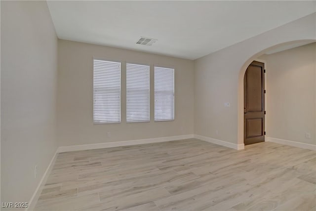 8544 Garden Valley Ct, Las Vegas, NV 89178 - spare room with arched walkways, light wood-style floors, plenty of natural light, and baseboards
