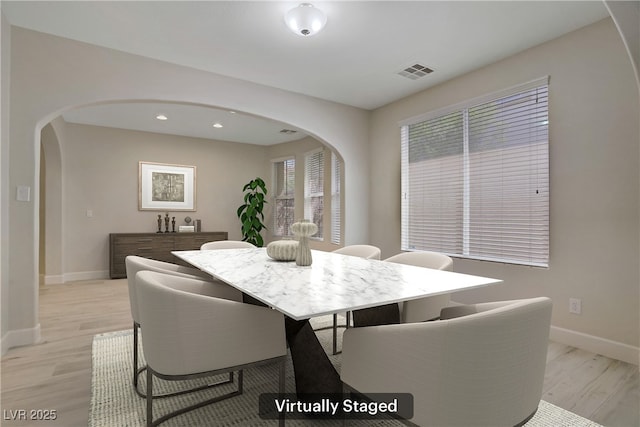 8544 Garden Valley Ct, Las Vegas, NV 89178 - dining area with arched walkways, light wood-style floors, baseboards, and recessed lighting