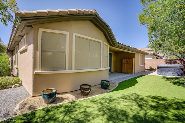 8544 Garden Valley Ct, Las Vegas, NV 89178 - view of property exterior featuring a hot tub, stucco siding, a patio, and a tile roof