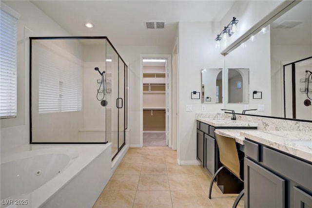 8544 Garden Valley Ct, Las Vegas, NV 89178 - full bathroom featuring a stall shower, double vanity, a whirlpool tub, tile patterned floors, and a spacious closet