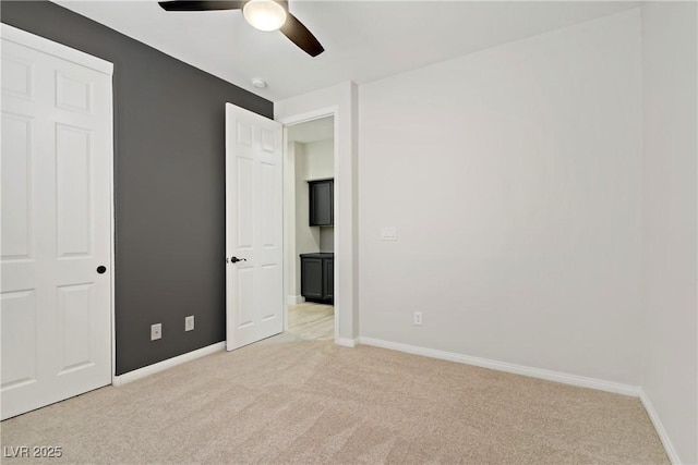 8544 Garden Valley Ct, Las Vegas, NV 89178 - unfurnished bedroom featuring light carpet, baseboards, and ceiling fan