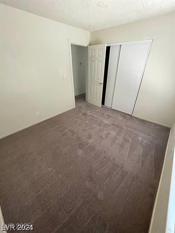 45 Logan Ct, Las Vegas, NV 89110 - unfurnished bedroom featuring a textured ceiling, carpet flooring, and a closet