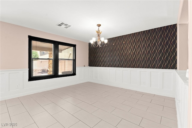 11755 Garland Grove Ln, Las Vegas, NV 89183 - empty room featuring a chandelier, a decorative wall, and a wainscoted wall