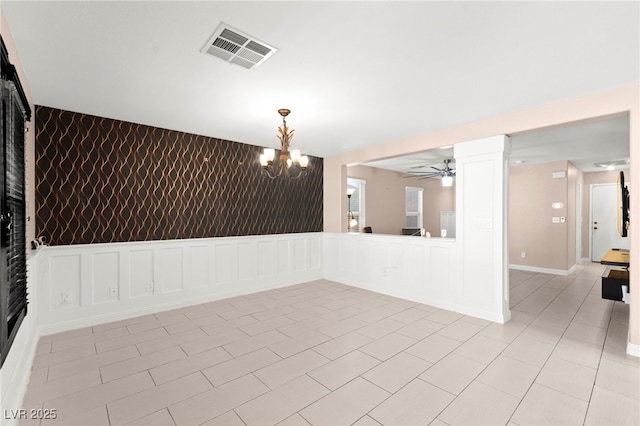 11755 Garland Grove Ln, Las Vegas, NV 89183 - unfurnished room with a chandelier, a decorative wall, light tile patterned floors, ceiling fan, and ornate columns