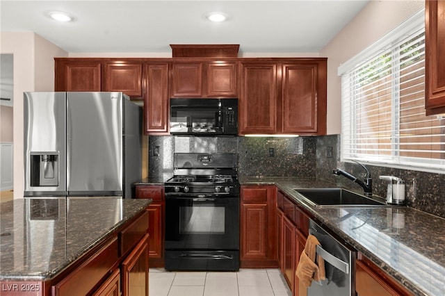 11755 Garland Grove Ln, Las Vegas, NV 89183 - kitchen featuring black appliances, a sink, tasteful backsplash, dark stone countertops, and light tile patterned floors
