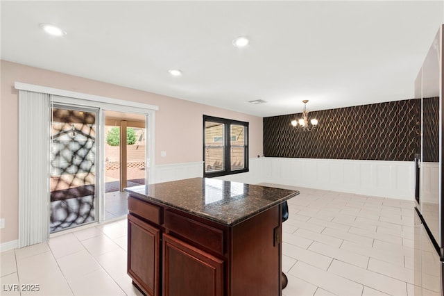 11755 Garland Grove Ln, Las Vegas, NV 89183 - kitchen featuring a chandelier, wainscoting, dark stone counters, french doors, and recessed lighting