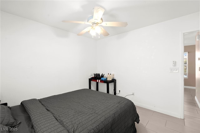 11755 Garland Grove Ln, Las Vegas, NV 89183 - bedroom with light tile patterned floors, a ceiling fan, and baseboards