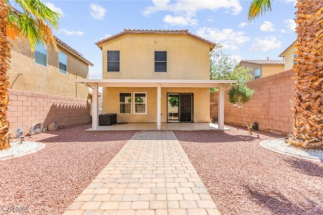 11755 Garland Grove Ln, Las Vegas, NV 89183 - back of property featuring stucco siding, a fenced backyard, and a patio