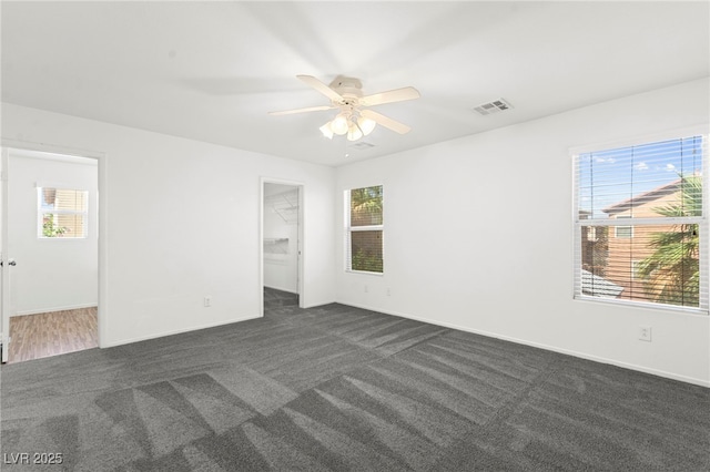 11755 Garland Grove Ln, Las Vegas, NV 89183 - unfurnished room with dark colored carpet, a ceiling fan, and baseboards
