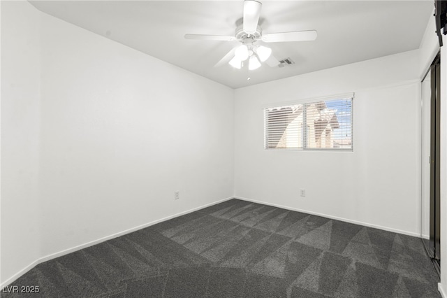 11755 Garland Grove Ln, Las Vegas, NV 89183 - unfurnished bedroom with dark carpet, baseboards, and a ceiling fan