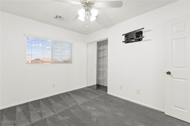 11755 Garland Grove Ln, Las Vegas, NV 89183 - unfurnished bedroom featuring dark carpet, baseboards, a closet, and a ceiling fan