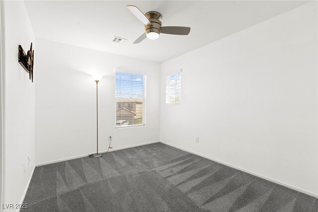 11755 Garland Grove Ln, Las Vegas, NV 89183 - spare room featuring dark colored carpet, ceiling fan, and baseboards