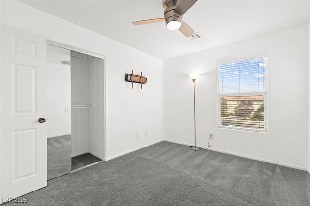 11755 Garland Grove Ln, Las Vegas, NV 89183 - unfurnished bedroom featuring dark colored carpet, a closet, a ceiling fan, and baseboards