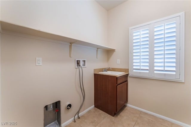 6125 Paddleboat St, North Las Vegas, NV 89031 - laundry room featuring hookup for a washing machine, hookup for a gas dryer, cabinet space, baseboards, and light tile patterned floors
