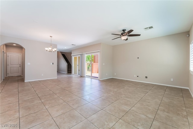 6125 Paddleboat St, North Las Vegas, NV 89031 - empty room with light tile patterned floors, stairs, arched walkways, ceiling fan, and a chandelier