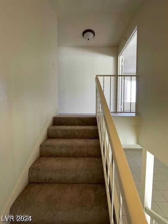 5243 Sunnywood Dr, Las Vegas, NV 89120 - stairway with carpet floors