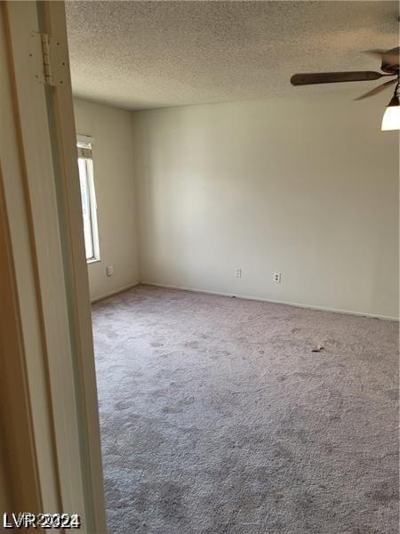 5243 Sunnywood Dr, Las Vegas, NV 89120 - carpeted empty room with ceiling fan and a textured ceiling