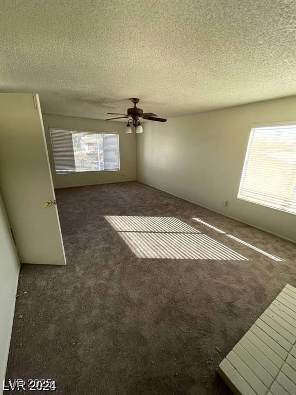 5243 Sunnywood Dr, Las Vegas, NV 89120 - unfurnished bedroom featuring carpet flooring, a textured ceiling, and a ceiling fan