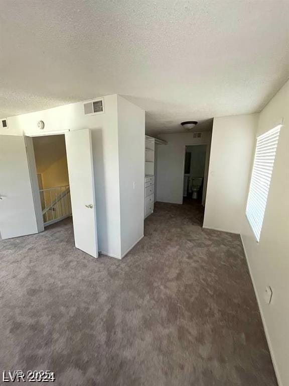 5243 Sunnywood Dr, Las Vegas, NV 89120 - spare room featuring carpet flooring and a textured ceiling