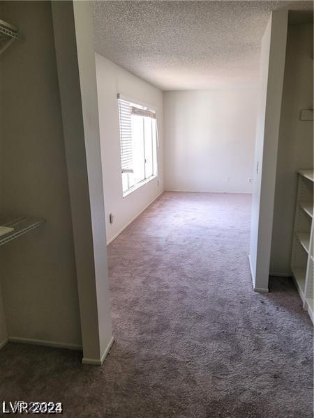 5243 Sunnywood Dr, Las Vegas, NV 89120 - unfurnished living room featuring carpet, a textured ceiling, and baseboards