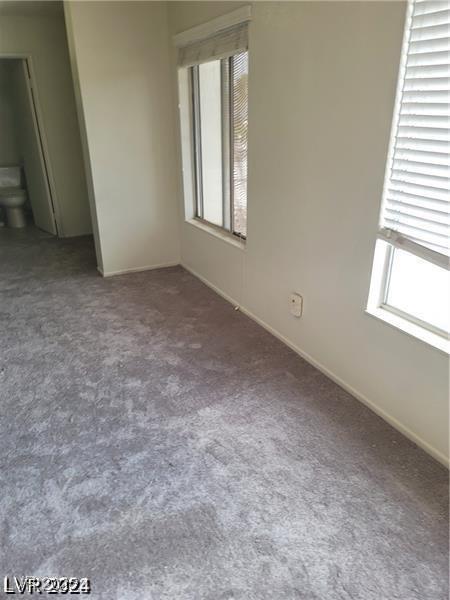 5243 Sunnywood Dr, Las Vegas, NV 89120 - spare room featuring healthy amount of natural light, carpet flooring, and baseboards