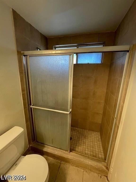 5243 Sunnywood Dr, Las Vegas, NV 89120 - bathroom featuring toilet, a shower stall, and tile patterned floors