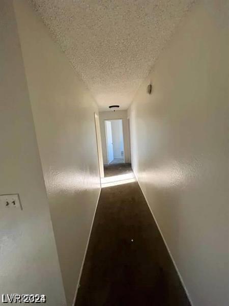 5243 Sunnywood Dr, Las Vegas, NV 89120 - hall with a textured ceiling and baseboards