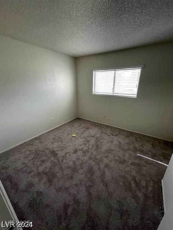 5243 Sunnywood Dr, Las Vegas, NV 89120 - empty room with carpet floors, a textured ceiling, and baseboards