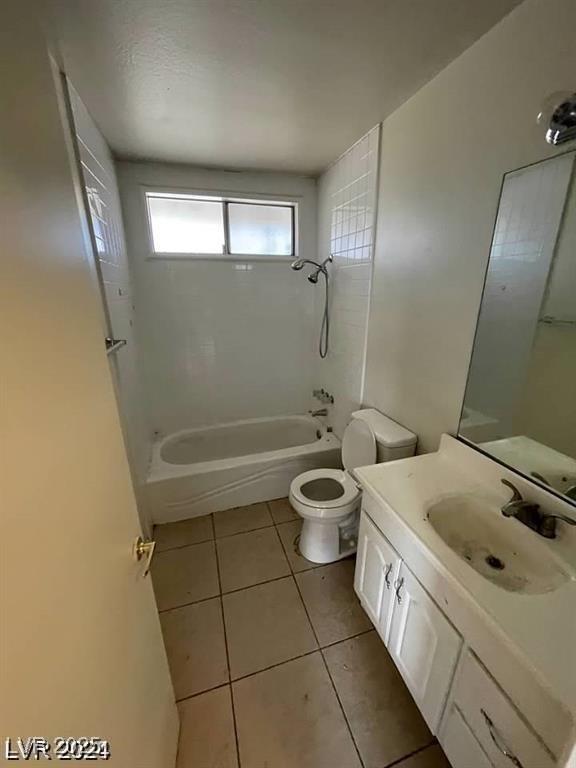5243 Sunnywood Dr, Las Vegas, NV 89120 - bathroom featuring toilet, tile patterned flooring, vanity, and tub / shower combination