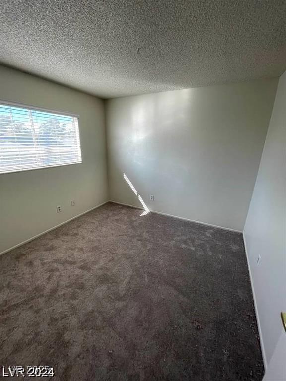 5243 Sunnywood Dr, Las Vegas, NV 89120 - carpeted empty room with a textured ceiling