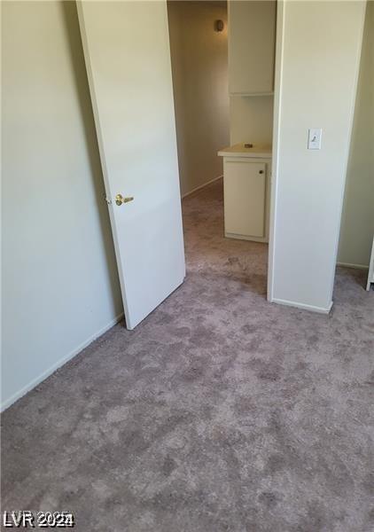 5243 Sunnywood Dr, Las Vegas, NV 89120 - unfurnished bedroom featuring carpet floors and baseboards
