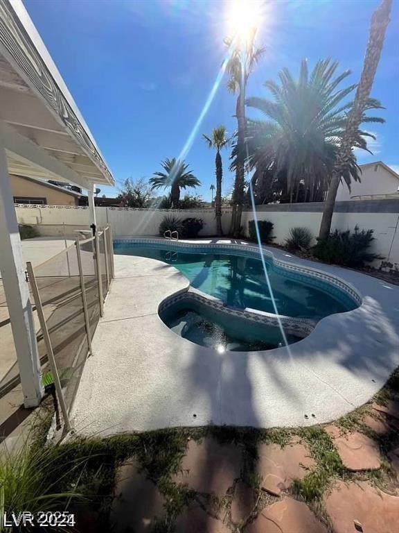 5243 Sunnywood Dr, Las Vegas, NV 89120 - view of pool with a fenced backyard and a pool with connected hot tub