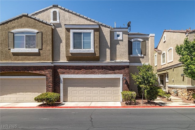 939 Paisley St, Las Vegas, NV 89145 - multi unit property featuring stucco siding, an attached garage, and brick siding