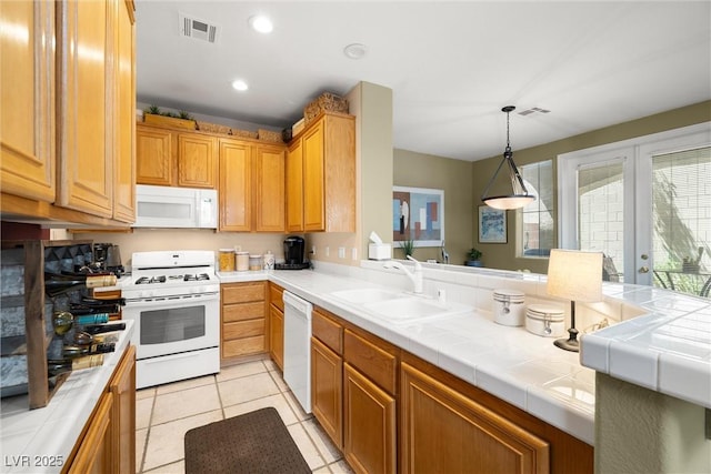 939 Paisley St, Las Vegas, NV 89145 - kitchen featuring white appliances, a sink, hanging light fixtures, recessed lighting, and tile countertops