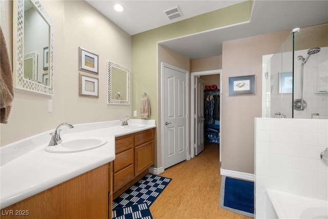 939 Paisley St, Las Vegas, NV 89145 - bathroom featuring a shower, double vanity, a bath, and a spacious closet