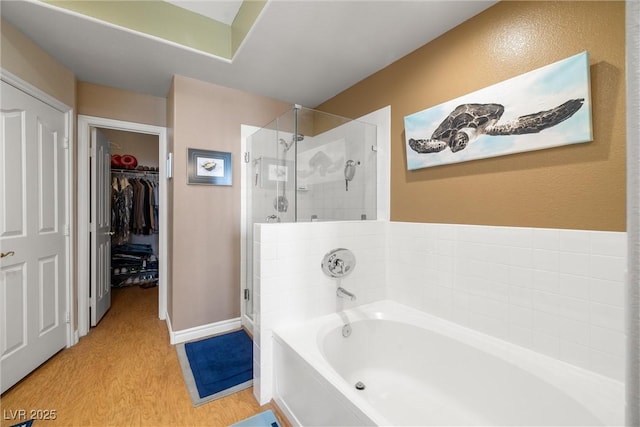 939 Paisley St, Las Vegas, NV 89145 - bathroom with a stall shower, a garden tub, a walk in closet, and wood finished floors