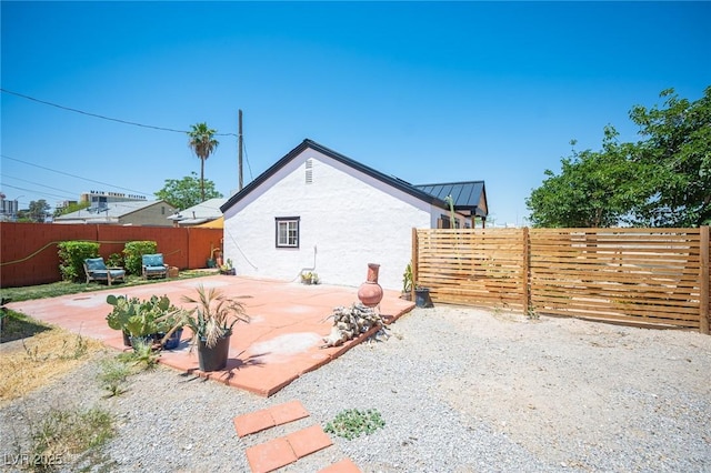 108 Verdy Ln, Las Vegas, NV 89101 - view of home's exterior with stucco siding, a patio area, a standing seam roof, and metal roof